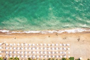 Aerial top view on the beach of Belek, Turkey. Umbrellas, sand and mediterranean sea. Turkish landscape